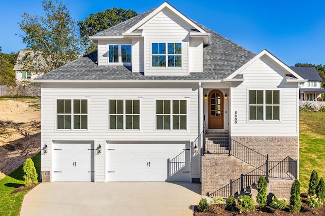 8668 Woodbury Acre Ct, Harrison, TN 37341 - traditional-style house featuring a garage, a shingled roof, concrete driveway, and stairs