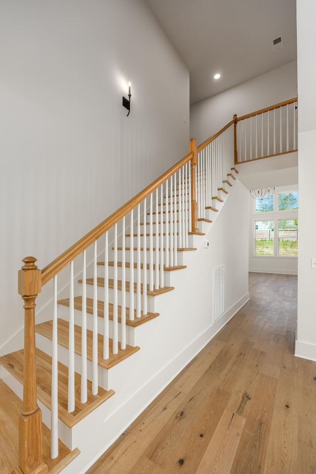 8668 Woodbury Acre Ct, Harrison, TN 37341 - stairs featuring wood finished floors, recessed lighting, and a chandelier