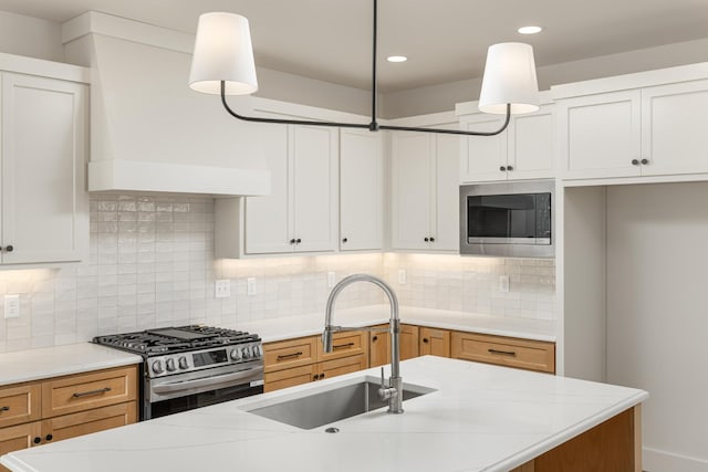 8668 Woodbury Acre Ct, Harrison, TN 37341 - kitchen with appliances with stainless steel finishes, decorative backsplash, recessed lighting, hanging light fixtures, and premium range hood