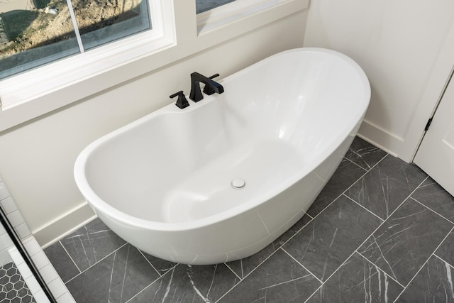 8668 Woodbury Acre Ct, Harrison, TN 37341 - bathroom view of baseboards and a freestanding tub