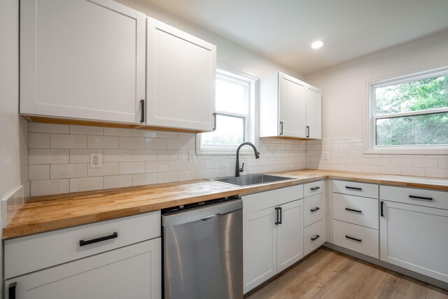 35 Agnes Ave, Chattanooga, TN 37406 - kitchen with stainless steel dishwasher, wooden counters, white cabinets, decorative backsplash, and recessed lighting
