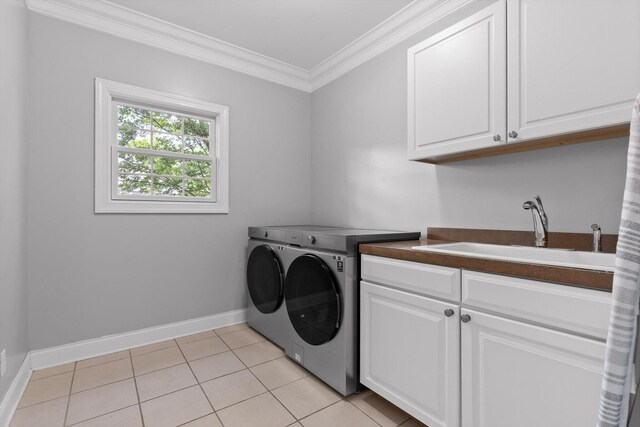 715 Forest Ave, Chattanooga, TN 37405 - washroom featuring cabinet space, washer and dryer, ornamental molding, and light tile patterned floors