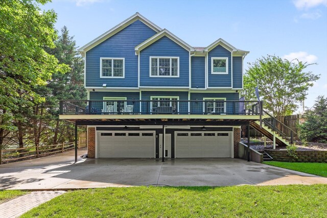 715 Forest Ave, Chattanooga, TN 37405 - view of front of house featuring an attached garage, concrete driveway, brick siding, and stairs