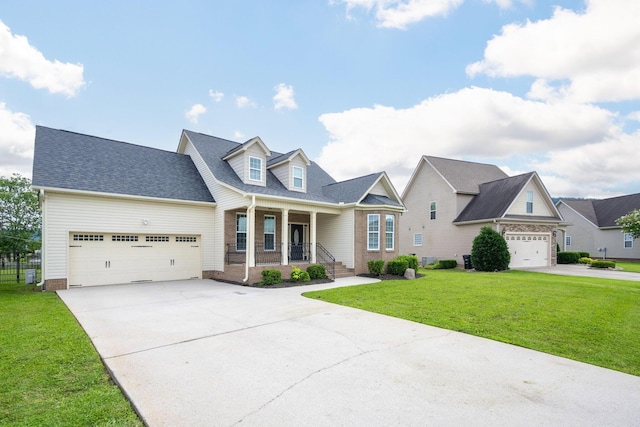8539 Lexie Ln, Ooltewah, TN 37363 - cape cod-style house with covered porch, an attached garage, driveway, a front lawn, and brick siding
