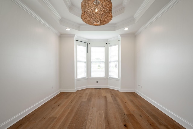 8539 Lexie Ln, Ooltewah, TN 37363 - unfurnished room featuring a chandelier, wood finished floors, recessed lighting, a raised ceiling, and crown molding
