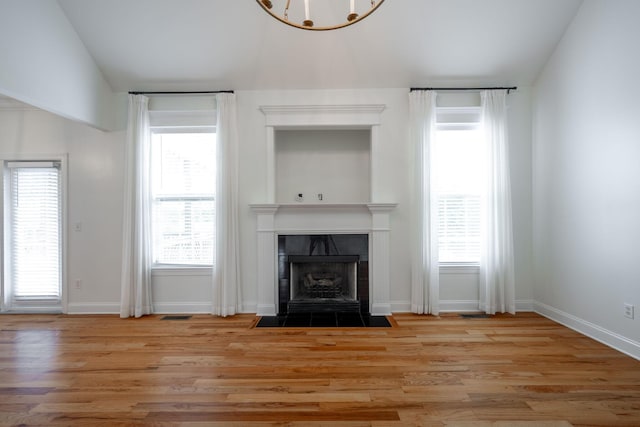 8539 Lexie Ln, Ooltewah, TN 37363 - unfurnished living room featuring light wood-type flooring, a fireplace, and healthy amount of natural light
