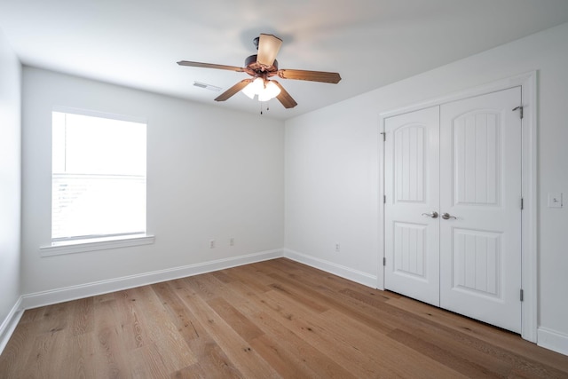 8539 Lexie Ln, Ooltewah, TN 37363 - unfurnished bedroom with wood finished floors, a closet, and a ceiling fan