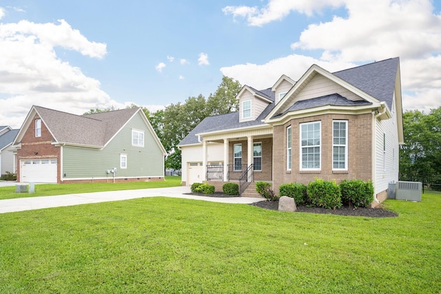 8539 Lexie Ln, Ooltewah, TN 37363 - view of front of home featuring concrete driveway, a front lawn, brick siding, a porch, and an attached garage