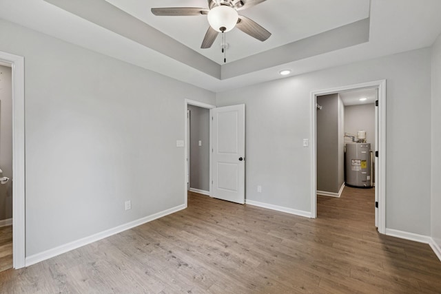 521 5th Ave N, Lewisburg, TN 37091 - unfurnished bedroom with electric water heater, wood finished floors, a raised ceiling, recessed lighting, and a ceiling fan