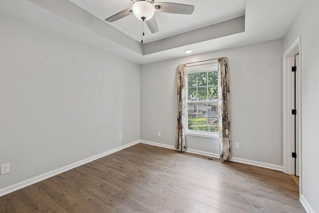 521 5th Ave N, Lewisburg, TN 37091 - spare room with wood finished floors, ceiling fan, and a raised ceiling