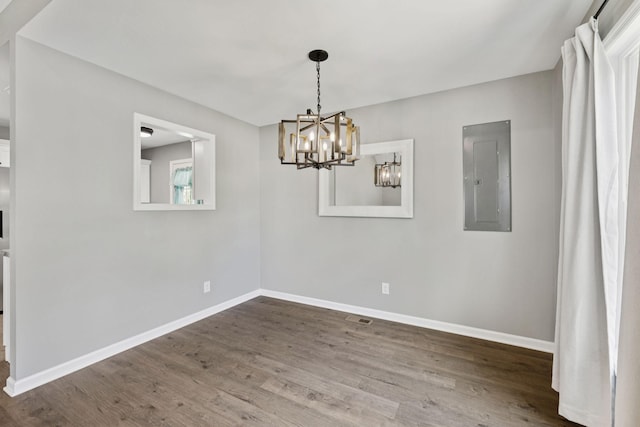 521 5th Ave N, Lewisburg, TN 37091 - empty room featuring electric panel, a chandelier, and wood finished floors