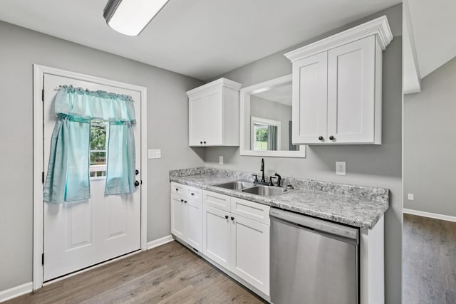 521 5th Ave N, Lewisburg, TN 37091 - kitchen with stainless steel dishwasher, white cabinetry, and light wood-style floors
