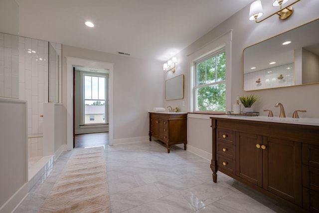 414 W College St, Dickson, TN 37055 - full bathroom with healthy amount of natural light, two vanities, walk in shower, marble look tile flooring, and recessed lighting