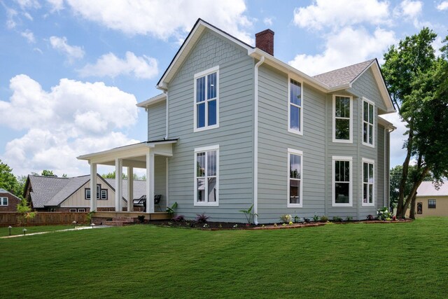 414 W College St, Dickson, TN 37055 - rear view of property featuring a chimney, a yard, and a porch