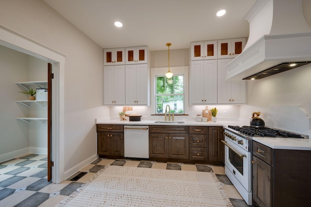 414 W College St, Dickson, TN 37055 - kitchen with white appliances, custom exhaust hood, white cabinetry, dark brown cabinetry, and light flooring
