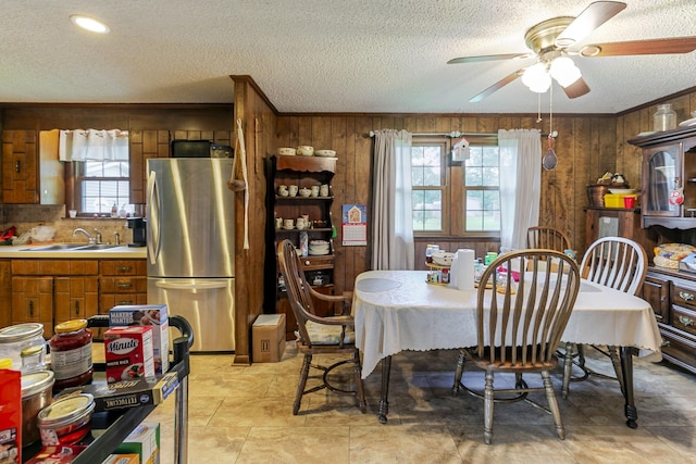 2802 Canterbury Dr, Springfield, TN 37172 - dining space featuring a textured ceiling, healthy amount of natural light, a ceiling fan, and wood walls