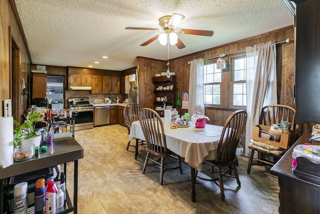 2802 Canterbury Dr, Springfield, TN 37172 - dining area featuring a ceiling fan, wood walls, and a textured ceiling