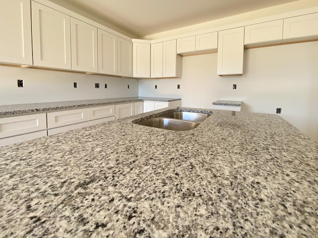 305 Towles Ave Unit B, Mcminnville, TN 37110 - kitchen with light stone countertops and white cabinetry