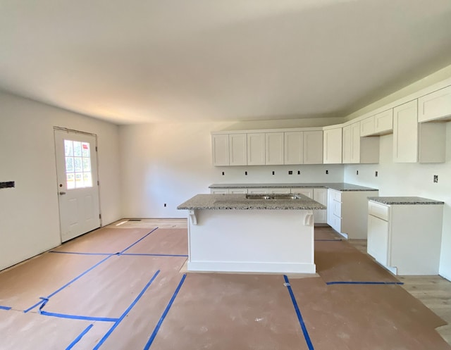 305 Towles Ave Unit A, Mcminnville, TN 37110 - kitchen with stone countertops, white cabinets, and a kitchen island