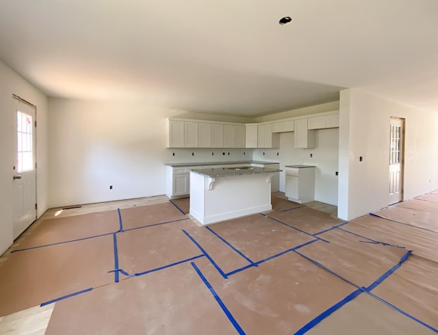 305 Towles Ave Unit A, Mcminnville, TN 37110 - kitchen with a kitchen island and white cabinetry