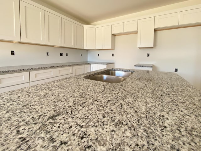 305 Towles Ave Unit A, Mcminnville, TN 37110 - kitchen with light stone countertops and white cabinets