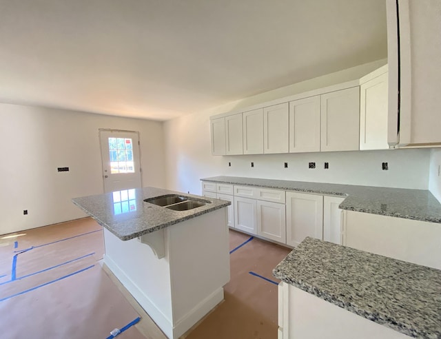 305 Towles Ave Unit A, Mcminnville, TN 37110 - kitchen featuring stone countertops, a kitchen island with sink, and white cabinets