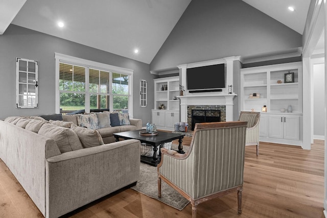 1014 Douglas Ct, Dickson, TN 37055 - living room with high vaulted ceiling, a brick fireplace, light wood-style flooring, and recessed lighting
