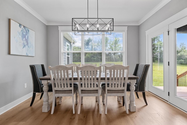 1014 Douglas Ct, Dickson, TN 37055 - dining space with light wood finished floors, crown molding, and a chandelier