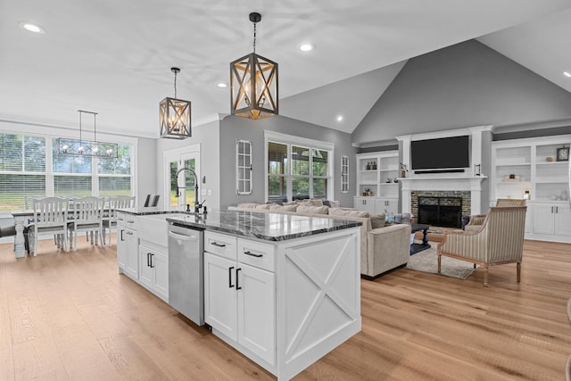 1014 Douglas Ct, Dickson, TN 37055 - kitchen featuring stainless steel dishwasher, recessed lighting, white cabinetry, dark stone countertops, and a fireplace