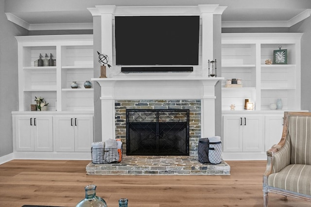 1014 Douglas Ct, Dickson, TN 37055 - living room featuring ornamental molding, light wood-style floors, a brick fireplace, and built in shelves