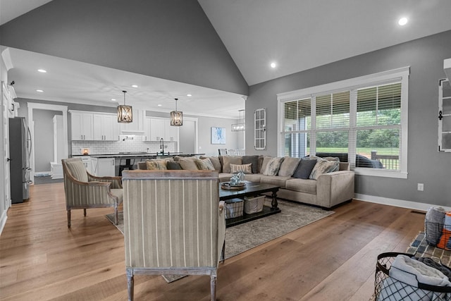 1014 Douglas Ct, Dickson, TN 37055 - living room with recessed lighting, light wood finished floors, high vaulted ceiling, and a chandelier