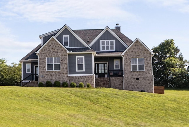 1014 Douglas Ct, Dickson, TN 37055 - craftsman-style house with a front yard, a chimney, brick siding, and board and batten siding