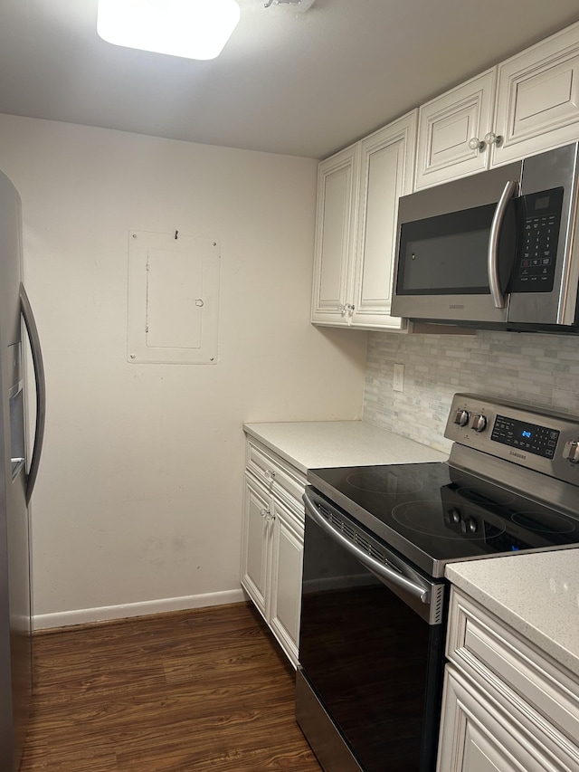 604 Granville Rd Unit 604, Franklin, TN 37064 - kitchen featuring appliances with stainless steel finishes, decorative backsplash, electric panel, dark wood-type flooring, and light countertops
