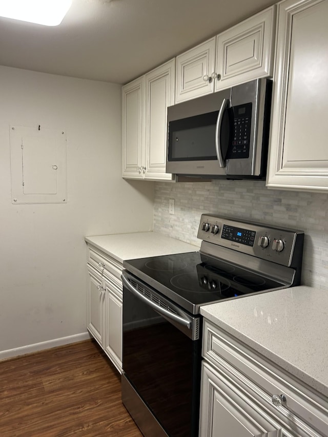 604 Granville Rd Unit 604, Franklin, TN 37064 - kitchen with appliances with stainless steel finishes, decorative backsplash, dark wood-type flooring, electric panel, and white cabinetry
