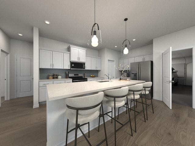 1521 Bear Branch Trce, Columbia, TN 38401 - kitchen featuring appliances with stainless steel finishes, wood finished floors, light countertops, an island with sink, and recessed lighting