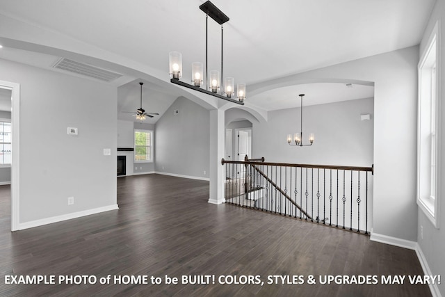 1988 Flats Rd, Cunningham, TN 37052 - unfurnished room featuring a ceiling fan, dark wood finished floors, arched walkways, a chandelier, and a fireplace