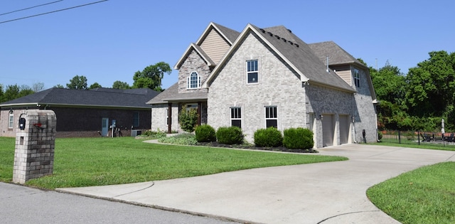 216 Honeysuckle Ln, Lebanon, TN 37087 - french country inspired facade featuring concrete driveway, an attached garage, and brick siding
