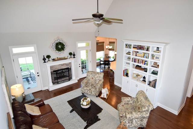 216 Honeysuckle Ln, Lebanon, TN 37087 - living room featuring lofted ceiling, wood finished floors, a ceiling fan, a chandelier, and a brick fireplace