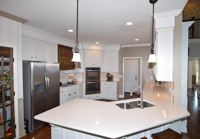 216 Honeysuckle Ln, Lebanon, TN 37087 - kitchen with appliances with stainless steel finishes, a peninsula, white cabinetry, decorative backsplash, and ornamental molding