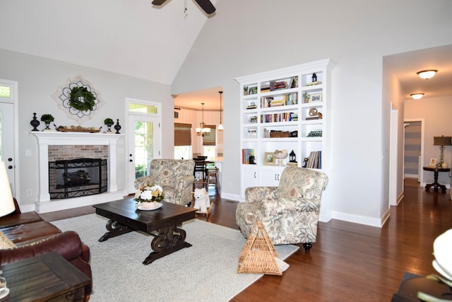 216 Honeysuckle Ln, Lebanon, TN 37087 - living room featuring ceiling fan, wood finished floors, a chandelier, a brick fireplace, and high vaulted ceiling