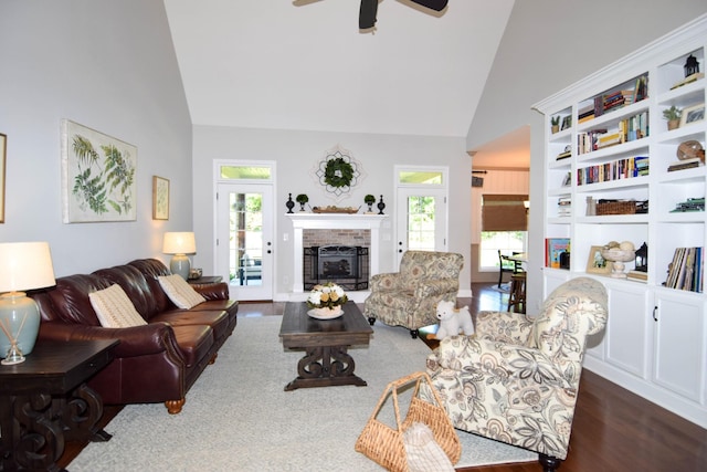 216 Honeysuckle Ln, Lebanon, TN 37087 - living room with high vaulted ceiling, ceiling fan, a brick fireplace, and wood finished floors