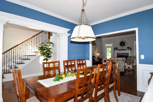 216 Honeysuckle Ln, Lebanon, TN 37087 - dining room featuring decorative columns, wood finished floors, crown molding, stairway, and a brick fireplace