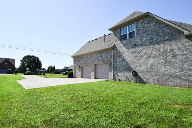 216 Honeysuckle Ln, Lebanon, TN 37087 - view of property exterior featuring concrete driveway, a lawn, roof with shingles, brick siding, and a garage