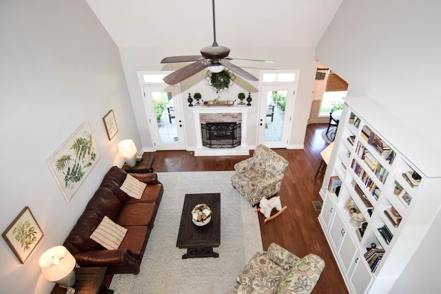 216 Honeysuckle Ln, Lebanon, TN 37087 - living room featuring ceiling fan, dark wood-style flooring, a fireplace with raised hearth, and vaulted ceiling