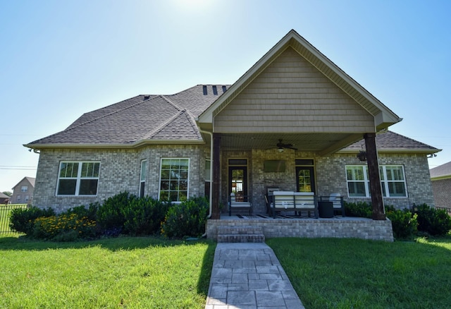 216 Honeysuckle Ln, Lebanon, TN 37087 - view of front facade with ceiling fan, a front yard, brick siding, and roof with shingles