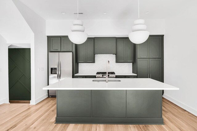 18 Willis St Unit A, Nashville, TN 37207 - kitchen featuring stainless steel refrigerator with ice dispenser, decorative backsplash, light countertops, and light wood-type flooring