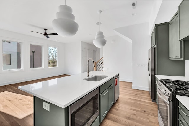 18 Willis St Unit A, Nashville, TN 37207 - kitchen with stainless steel appliances, light countertops, light wood finished floors, and a ceiling fan