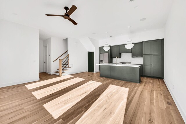 18 Willis St Unit A, Nashville, TN 37207 - kitchen with stainless steel refrigerator with ice dispenser, ceiling fan, light countertops, decorative backsplash, and an island with sink