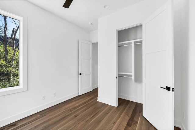 18 Willis St Unit C, Nashville, TN 37207 - unfurnished bedroom with multiple windows, dark wood finished floors, a closet, and a ceiling fan