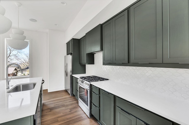 18 Willis St Unit C, Nashville, TN 37207 - kitchen featuring stainless steel appliances, decorative backsplash, and light countertops